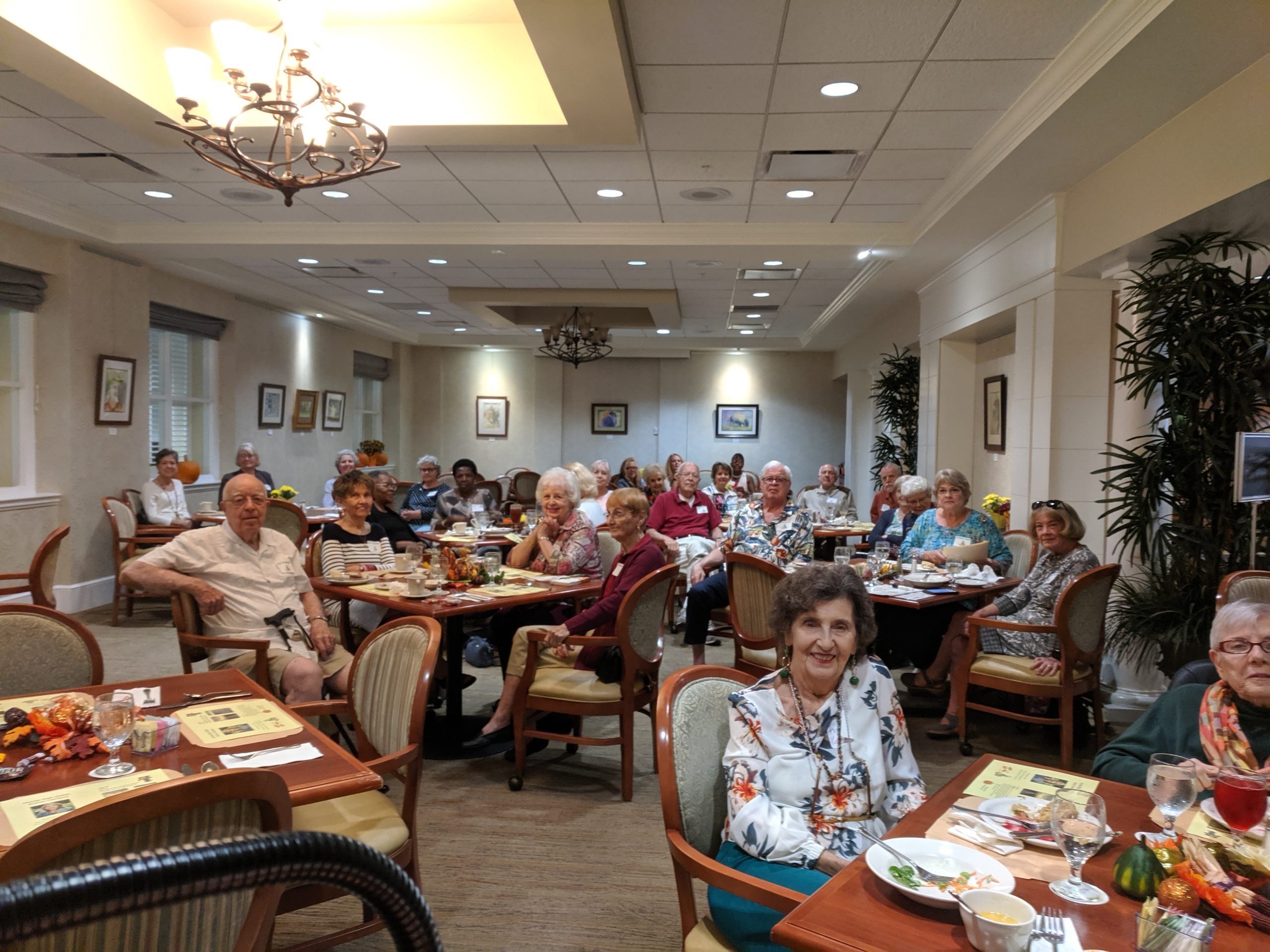 Crowd of people listening to Sarah Carey's poetry reading at Westminster Oaks in the dining hall.