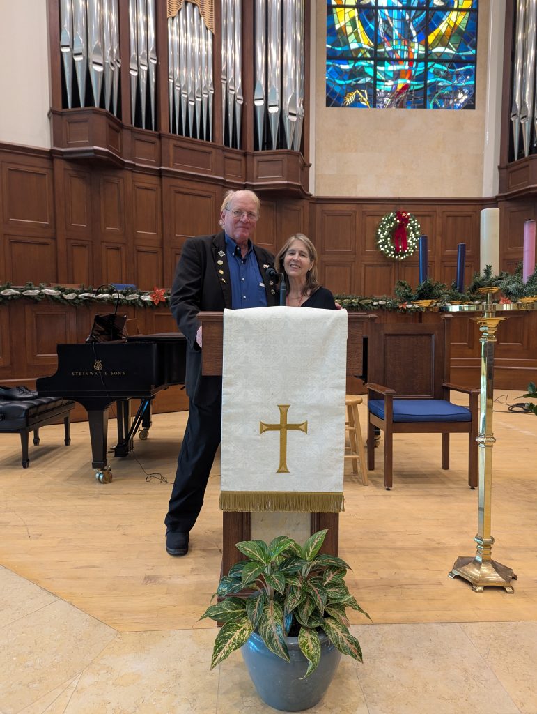 Photo of Sarah Carey and Sean Sexton behind a pulpit at a church following Sarah's reading.