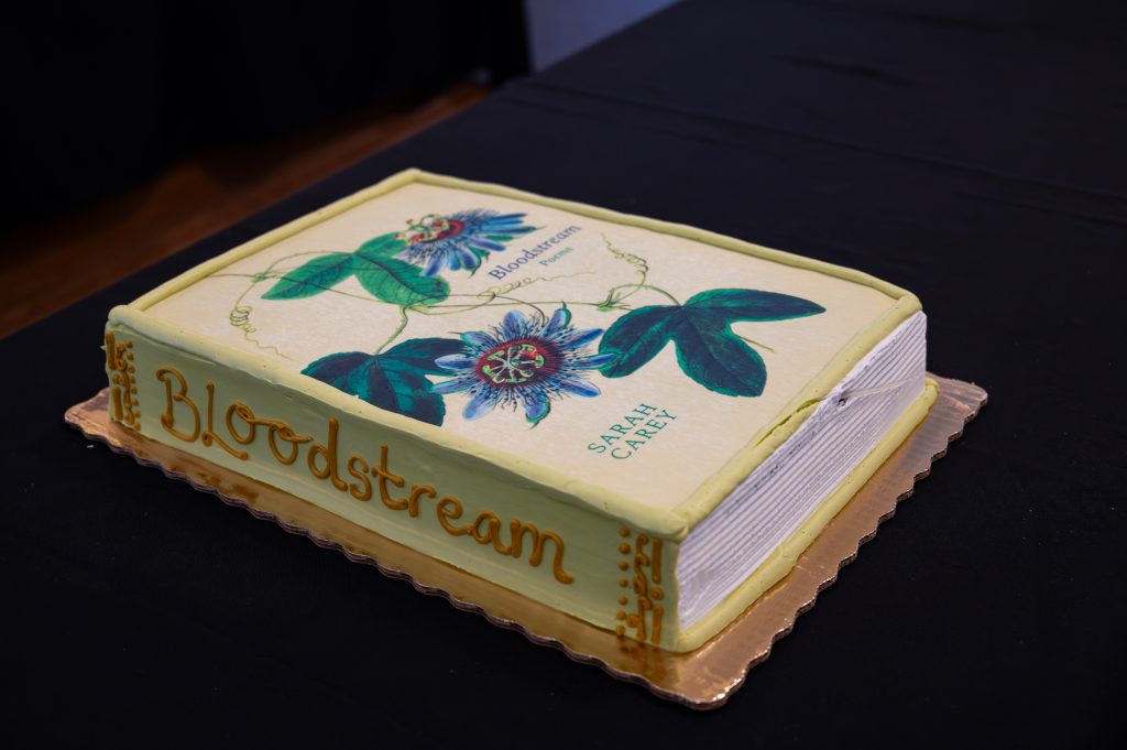 A 1/2 sheet cake with the cover of Bloodstream used as an edible-image topper.